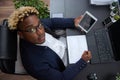 Top view of an African employee working with a tablet, sitting at an office desk Royalty Free Stock Photo