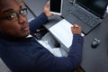 Top view of an African employee working with a tablet, sitting at an office desk Royalty Free Stock Photo