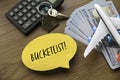 Top view of airplane model , money, house key, calculator and yellow speech burble written with Bucketlist on wooden background