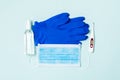 Top view of alcohol hand sanitizer, latex gloves, digital thermometer and medical mask on blue background. Virus protection Royalty Free Stock Photo