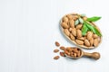 Top view Almond nuts in wooden shovel, almonds with shell in bamboo bowl Royalty Free Stock Photo