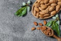 Top view Almond nuts in wooden shovel, almonds with shell in bamboo bowl Royalty Free Stock Photo