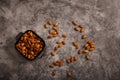 Top view of almonds on dark stone table with wood spoon or scoop. Almond in wooden bowl. Nuts freely laid on dark board. Royalty Free Stock Photo