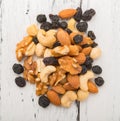 Top view almonds and walnuts and cashew nuts and raisin and dry blueberries on a wood table