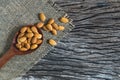 Top view almonds with wood spoon on dark wooden table background