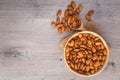 Top view of almonds on wooden table with wood spoon or scoop