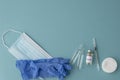 Top view of ampoules with vaccine, syringe,  medical mask and gloves on blue background, Royalty Free Stock Photo