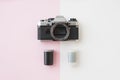 Top View of Analaog SLR Camera with 35 mm Film Canisters on Pink Royalty Free Stock Photo