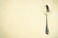 Top view of ancient silver spoon over wooden textured background. Royalty Free Stock Photo