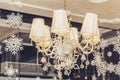Top view of an antique chandelier. A huge crystal gold chandelier with candles, against the backdrop of a spiral staircase and a