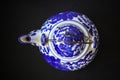 Top view antique white and blue ceramic teapot on black background, object background,  vintage, copy space Royalty Free Stock Photo