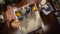 Top View Apartment: Happy Couple In Love Using Laptop in the Stylish Living Room, Hug and Look Up at Royalty Free Stock Photo