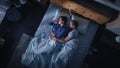 Top View Apartment: Happy Young Couple Side Cuddling Together in the Bed Sleeping at Night Royalty Free Stock Photo