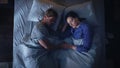 Top View Apartment: Happy Young Couple Sleeping in Bed at Night. Beautiful Girlfriend and Handsome Royalty Free Stock Photo
