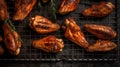 Top view of appetizing grilled chicken wings placed on metal grid on gray background