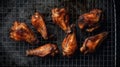 Top view of appetizing grilled chicken wings placed on metal grid on gray background