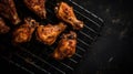 Top view of appetizing grilled chicken wings placed on metal grid on gray background Royalty Free Stock Photo