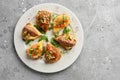 Top view on appetizing italian appetizers bruschettas on a white plate, horizontal Royalty Free Stock Photo