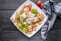 Top view appetizing salad with shrimp, lettuce, cheese, avocado and crackers on a white plate. Delicious and healthy seafood Royalty Free Stock Photo