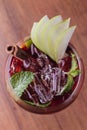 Top view of Apple cocktail with cinnamon and sliced fresh apple in wine glass on wooden table Royalty Free Stock Photo