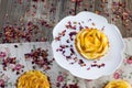 Top View on a Apple tartelette on a white plate with caramel glaze with rose petals