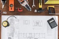 top view of architect blueprint tape measurement calculator and various tools