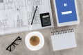 top view of architect workplace with blueprint divider coffee and digital tablet with facebook
