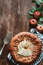 top view of arranged apple pie, cake server and fresh apples with green leaves Royalty Free Stock Photo