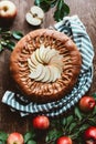 top view of arranged apple pie and fresh apples with green leaves Royalty Free Stock Photo