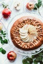 top view of arranged apple pie, fresh apples and green leaves Royalty Free Stock Photo