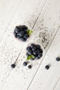 top view of arranged chia puddings with fresh blueberries and mint on white wooden surface Royalty Free Stock Photo