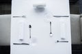 top view of arranged cutlery and wineglasses on table with white tablecloth