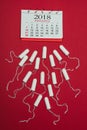 Top view of arranged menstrual tampons and calendar