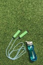 top view of arranged water bottle and skipping rope