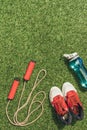 top view of arranged water bottle, skipping rope and sneakers