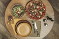 Top view of arrangement of empty plates, pizza and salad Royalty Free Stock Photo