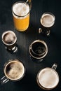 top view of arrangement of glasses of cold beer on dark