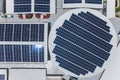 Top view of an array of polycrystalline solar panels installed on the roof of a shopping mall