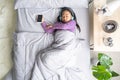 Top view Asian child little girl sleep, tired from smartphone Royalty Free Stock Photo