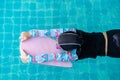 Top view Asian child little girl swims with board in the pool. Royalty Free Stock Photo