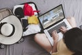 Top view Asian happy woman plan for trip by laptop booking hotel on the bed at home. Women with travel bag use notebook computer Royalty Free Stock Photo