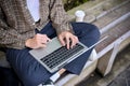 Top view of an Asian man sitting on bench in the park and using his portable laptop Royalty Free Stock Photo