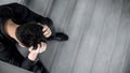 Asian man feeling stressed sitting on concrete stair Royalty Free Stock Photo