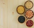 Top view assorted beans on wooden background