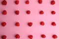 Top view of assorted delicious fresh raspberries on a pink background