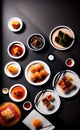 Top view on assorted dim sum in white dishes on a dark table