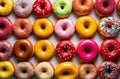 Top view of assorted glazed donuts. . Various colorful glazed doughnuts with sprinkles.