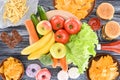 top view of assorted junk food and fresh fruits with vegetables on wooden table Royalty Free Stock Photo