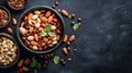 Assorted nuts in bowls on dark textured background Royalty Free Stock Photo