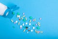 Top view of assorted scattered from pill bottle colorful tablets and capsules